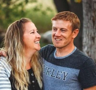Angela and Brandon Becker post outside for a photo